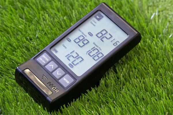 PRGR portable golf launch monitor placed on grass during golf practice session