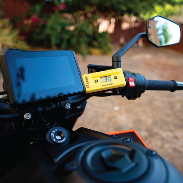 Slacker suspension sag tool mounted on motorcycle dashboard with wireless display