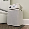 Austin Air HealthMate Junior compact air purifier with 360-degree intake and steel housing.