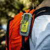 ACR ResQLink 400 personal locator beacon attached to backpack for hiking and outdoor safety use