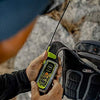 User holding ACR ResQLink 400 personal locator beacon outdoors for emergency signaling and GPS tracking