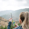 Person using ACR ResQLink View personal locator beacon outdoors for hiking emergency communication