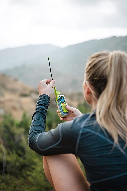 Person using ACR ResQLink View personal locator beacon outdoors for hiking emergency communication