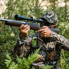 Hunter using ACR ResQLink View personal locator beacon in forest for outdoor emergency communication and safety