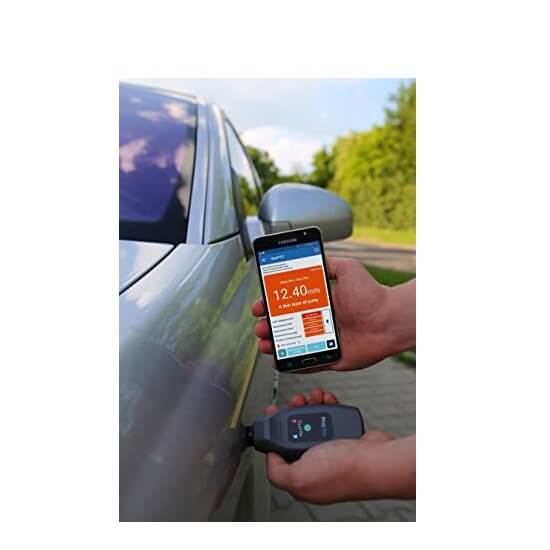 Using NexPTG coating thickness gauge on car panel with smartphone app displaying paint thickness data