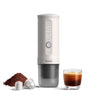OutIn Nano portable espresso maker with espresso cup, capsules, and ground coffee setup