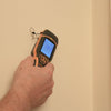 Handheld Protimeter SurveyMaster moisture meter detecting moisture near interior wall corner