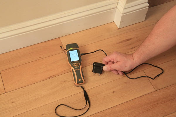 Protimeter SurveyMaster moisture meter using external probe attachment on wooden floor surface