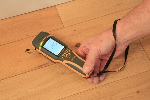 Protimeter SurveyMaster moisture meter measuring moisture content on hardwood flooring