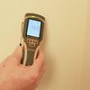 User checking wall moisture levels with Protimeter SurveyMaster moisture meter
