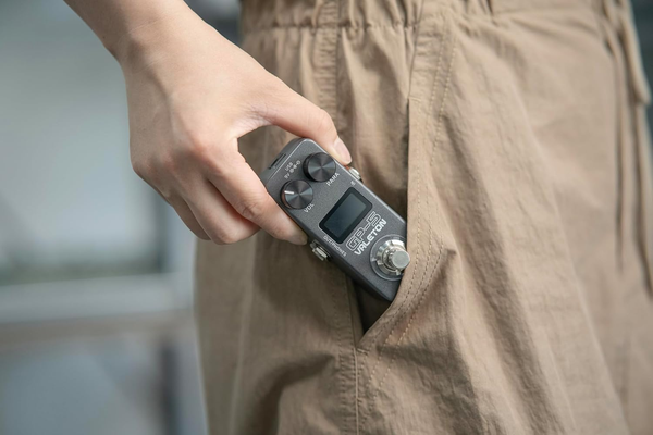 Valeton GP-5 compact multi effects pedal being placed in pocket highlighting portable design